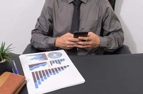 Check the staff report documents the growth of the business. At the desk Stock Photos