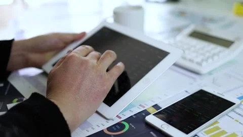Check the stock market with a tablet Stock Footage 193992509