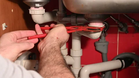 Check the water drainage circuit under the kitchen sink. With a sponge cloth the Stock Footage 147946037