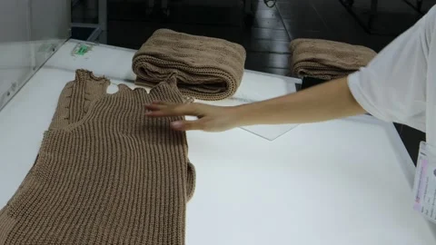 Checker is checking the quality of sweater panel Stock Footage 159534720