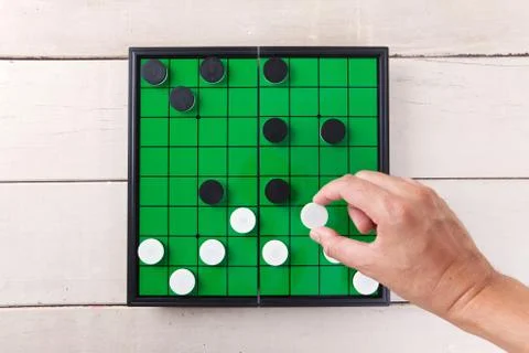 Checker game on green board view from above on wood table. Stock Photos