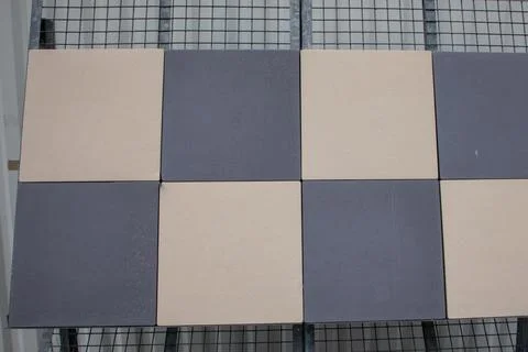 Checkerboard pattern of beige and grey ceramic tiles abstract background wi.. Stock Photos
