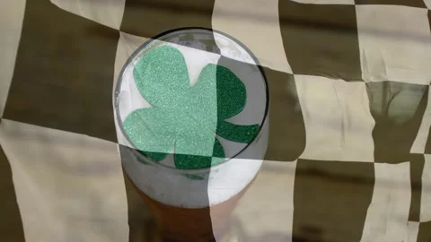 Checkered cloth rippling in breeze drifting over pint glass revealing tilting Stock Footage 329505583