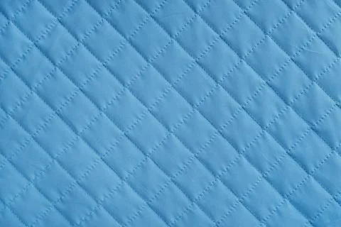 Checkered, diamond stitching pattern, blue quilted fabric background. Blank.. Stock-Fotos