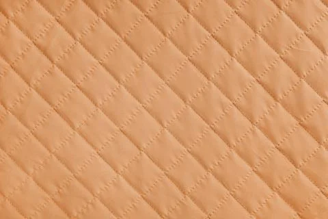 Checkered, diamond stitching pattern, orange quilted fabric background. Bla.. Foto stock