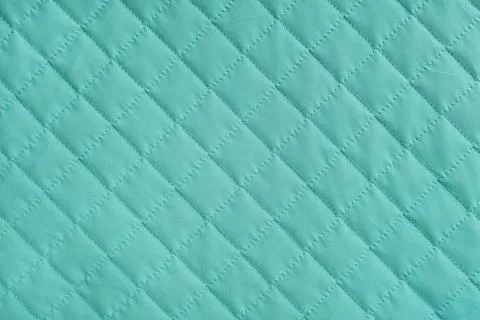 Checkered, diamond stitching pattern, turquoise quilted fabric background. .. 스톡 사진