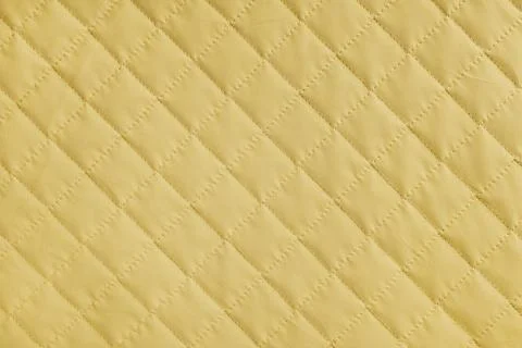 Checkered, diamond stitching pattern, yellow quilted fabric background. Bla.. Stock-Fotos