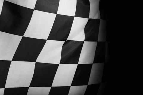Checkered finish flag on black background, closeup Stock Photos