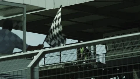 Checkered flag being waved at a race - Motorsport Stock Footage 70495801