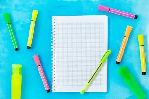 Checkered notebook with pen and multi-colored markers and felt-tip pens Stock Photos