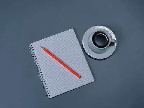 A checkered notebook with a pencil and a cup of coffee Stock Photos