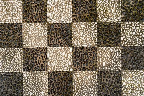 Checkered pattern mosaic floor made of black and white pebbles on the island in Stock Photos
