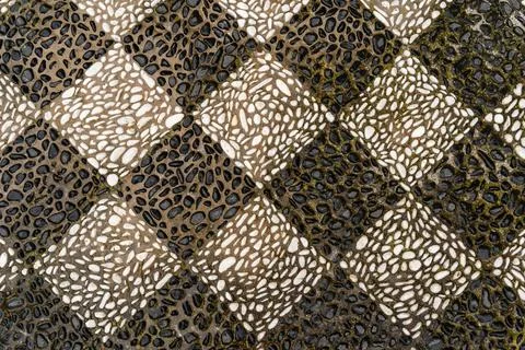 Checkered pattern mosaic floor made of black and white pebbles on the island in Stock Photos
