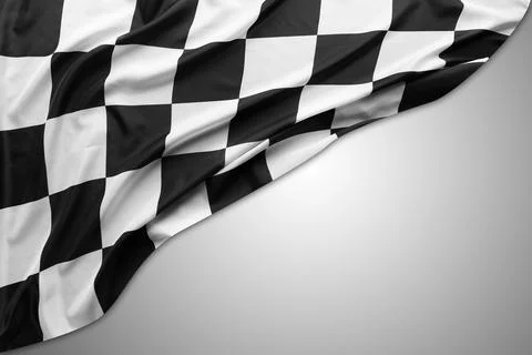 Checkered racing flag on grey Foto stock
