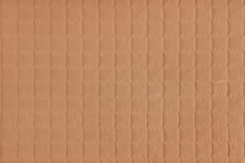 Checkered stitching pattern, orange quilted fabric background. Blanket stit.. Stockfoto's