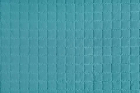 Checkered stitching pattern, turquoise quilted fabric background. Blanket s.. Stock-Fotos
