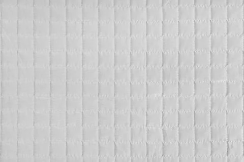 Checkered stitching pattern, white quilted fabric background. Blanket stitc.. Stock-Fotos