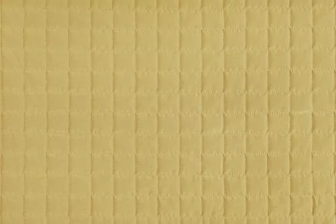 Checkered stitching pattern, yellow quilted fabric background. Blanket stit.. Stock Photos