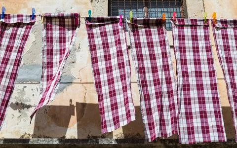 Checkered table cloths hanging out to dry Stock Photos