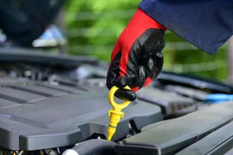Checking the amount of oil in the car engine via the level control rod Stock Photos