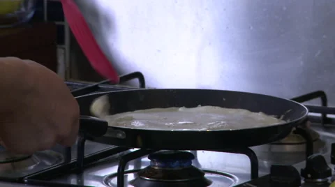 Checking and Flipping a Pancake in a Frying Pan Stock Footage 60018964