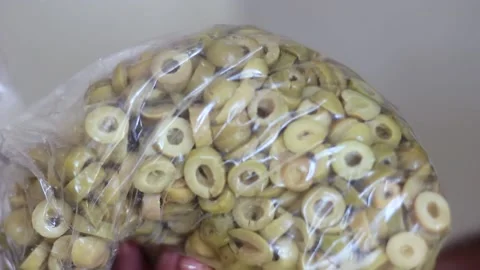 Checking and Holding Sliced Sliced Green Olives in Plastic Bag 스톡 동영상 148409719