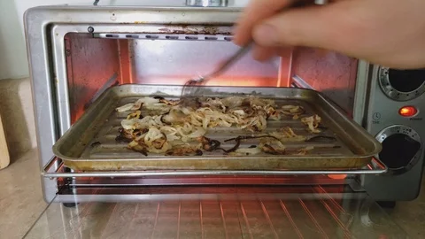 Checking and spreading roasting or broiling thin slices of onion mix with olive 스톡 동영상 102988082