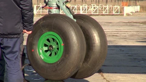 Checking angles of rotation of front landing gear of An-12 transport aircraft. Stock Footage 169927836