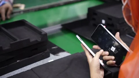 Checking back cameras and more android smartphone Production assembly line Stock Footage 247154477