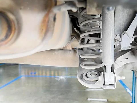 Checking back shock absorbers of car for repair and maintenance at car servic Stock Photos
