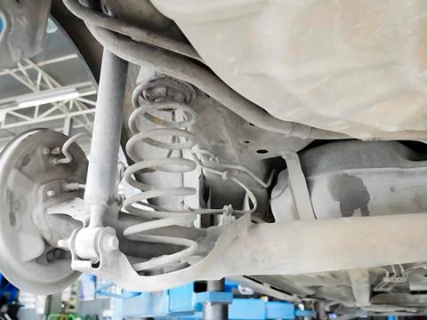 Checking back shock absorbers of car for repair and maintenance at car servic Stock Photos