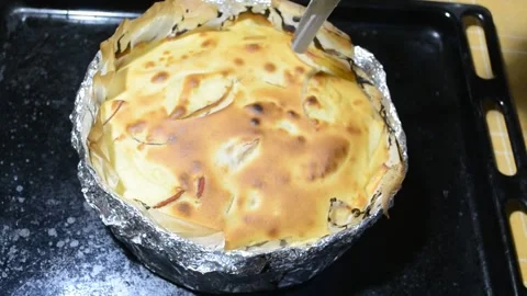 Checking the baking of the apple pie with a knife. Stock Footage 145719109