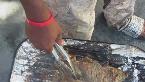 Checking the Barbeque in Sandals Stock Footage 237446977