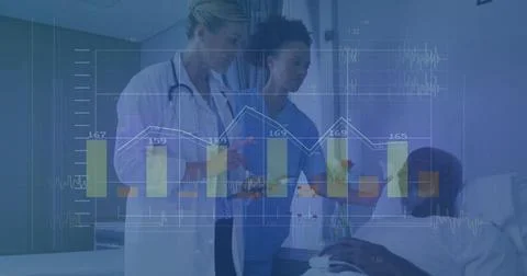 Checking bedside data, doctor in lab coat with stethoscope and tablet, nurse in Stock Photos