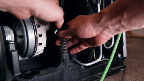 Checking the Belt Tensioner Spring of a tumble dryer Stock Footage 339900725