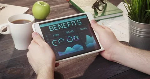 Checking benefits records using digital tablet at desk Stock Footage
