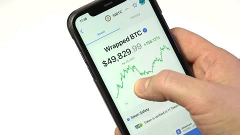 Checking bitcoin price  on smartphone. Stock exchange. Stock Footage 166019224