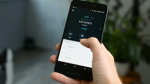 Checking Bitcoin wallet balance on mobile phone, your own bank in a smartphone 스톡 동영상 94078158