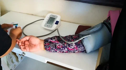 Checking blood pressure Stock Footage 107182183