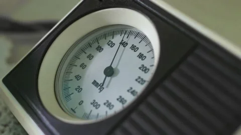 Checking blood pressure using manual arm blood pressure monitoring device Video stock 145767498