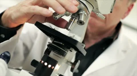 Checking blood sample under a microscope Stock Footage