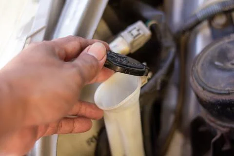 Checking brake fluid cap and washer reservoir handle during vehicle inspect.. Stock Photos
