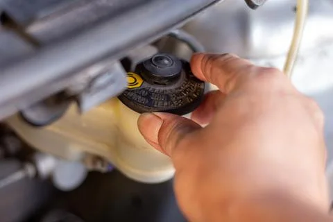 Checking brake fluid reservoir cap to ensure safe braking system performanc.. Stock Photos
