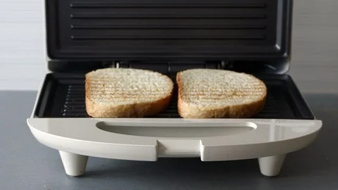 Checking bread in toaster Stock Footage 72559489