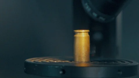 Checking bullet with microscope，criminal investigation，break a case Stock Footage 125461766