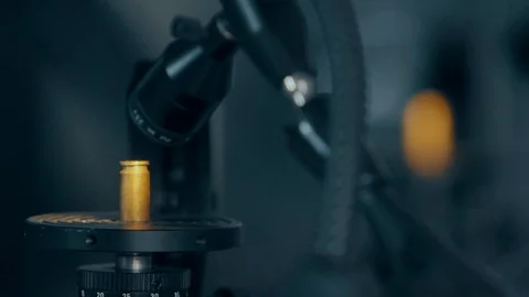 Checking bullet with microscope，criminal investigation，break a case Stock Footage 125461781