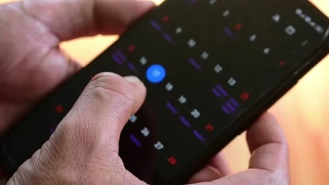 CHECKING CALENDAR ON MOBILE PHONE SCREEN 動画素材 143314432