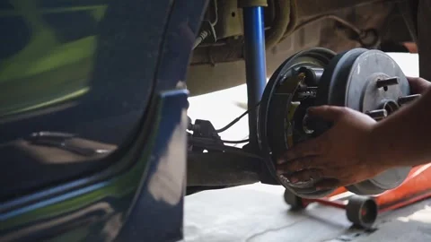 Checking car brake system for repair at car garage Stock Footage 303388706