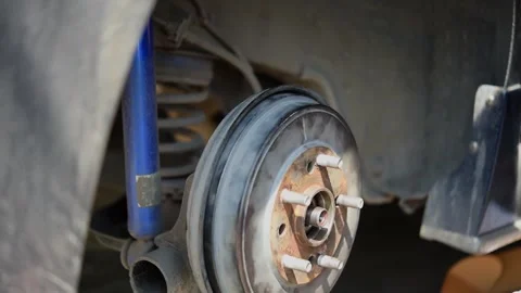 Checking car brake system for repair at car garage Stock Footage 303528189