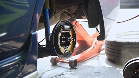 Checking car brake system for repair at car garage Stock Footage 305967783